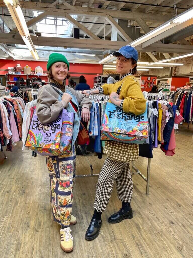 Two Buffalo Exchange customers carrying totes.