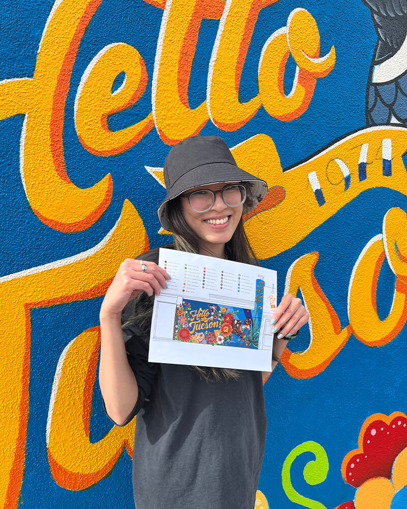 katie posing with the mural design