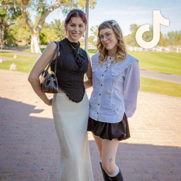 Two people with alt style wearing minimalist outfits of contrasting black and white tops and skirts with ruffle details, TikTok logo overlay at top right.